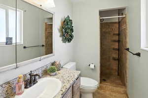 Full bathroom with vanity and a tile shower