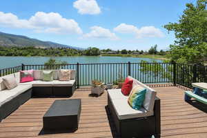 Deck featuring an outdoor living space and a water and mountain view