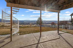 View of patio with stairs and a mountain view