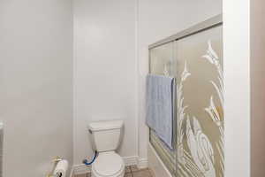 Bathroom featuring toilet and tile patterned flooring