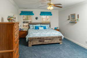 Bedroom featuring crown molding, carpet flooring, and a ceiling fan