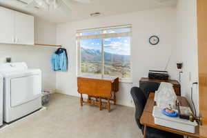 Laundry area with cabinet space, ceiling fan, light flooring, washer and dryer, and an office area