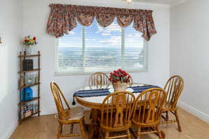 Dining area featuring light wood-style floors and ornamental molding