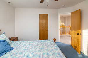 Bedroom featuring carpet flooring, a chandelier, and ceiling fan