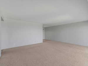 Spare room featuring carpet