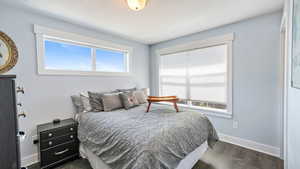 Bedroom with baseboards and dark wood finished floors