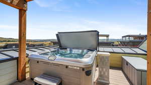 Wooden terrace featuring a hot tub