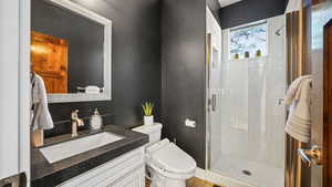 Bathroom featuring a shower stall and vanity