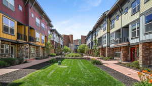 View of home's community with a lawn