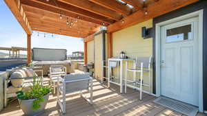 Deck featuring an outdoor hangout area and a hot tub