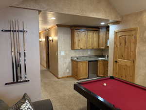 Playroom with vaulted ceiling, light carpet, pool table, and recessed lighting