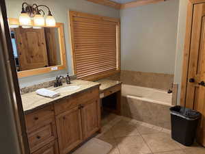 Full bath with a bath, tile patterned flooring, and vanity
