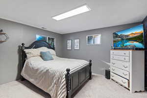 Bedroom featuring light colored carpet