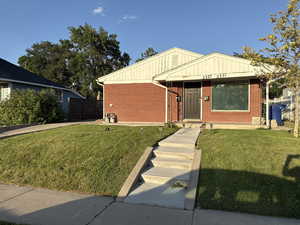 View of front of property featuring brick siding and board and batten siding