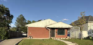 View of front of property with brick siding and board and batten siding