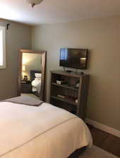 Bedroom featuring baseboards and wood finished floors