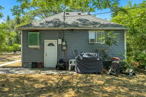 Rear view of property with roof with shingles