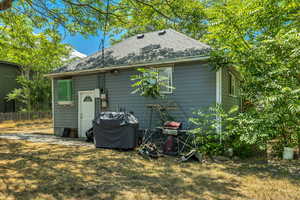Rear view of house featuring roof with shingles