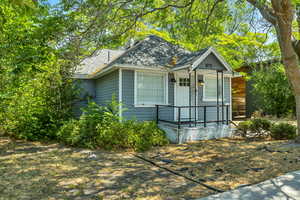 Bungalow featuring roof with shingles and covered porch