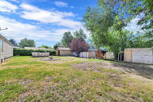 View of grassy yard featuring a storage shed