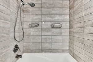 Full bath featuring shower / washtub combination