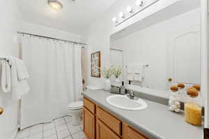 Bathroom featuring vanity, tile patterned floors, and shower / bathtub combination with curtain