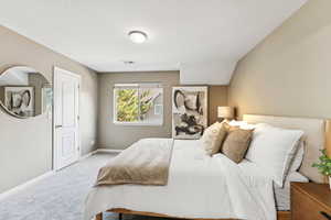 Bedroom with carpet and a textured ceiling