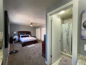 Carpeted bedroom featuring ceiling fan