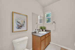 Half bathroom featuring vanity and tile patterned floors