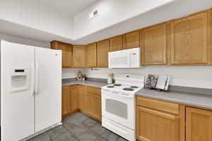 Kitchen with white appliances and light countertops