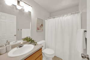 Bathroom with vanity and curtained shower
