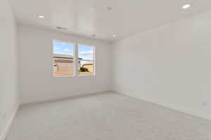 Spare room with light carpet and recessed lighting