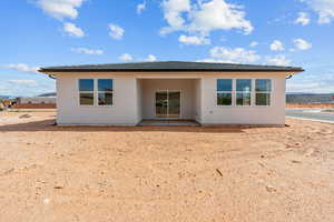 Rear view of property with a patio and stucco siding