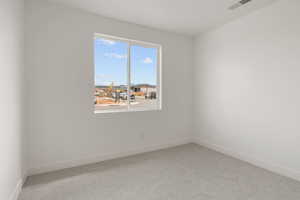 Empty room with carpet flooring and baseboards