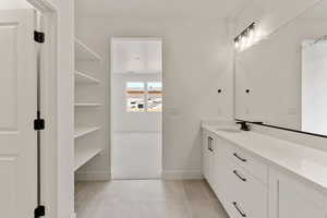 Full bath with vanity, light tile patterned floors, and light carpet