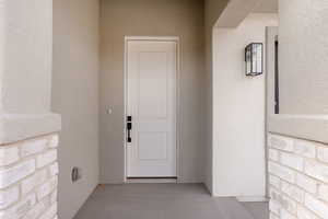 Entrance to property with stucco siding