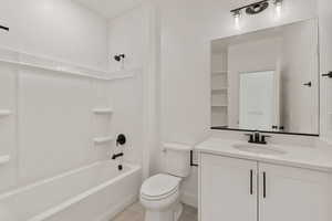 Bathroom featuring vanity, washtub / shower combination, and light tile patterned floors