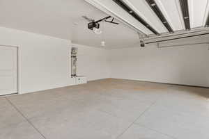 Garage with water heater and a garage door opener