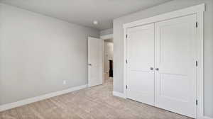 Unfurnished bedroom featuring carpet floors and a closet