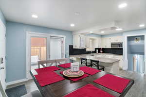 Dining area with recessed lighting and light wood-style flooring