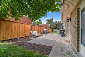 Fenced backyard featuring a patio