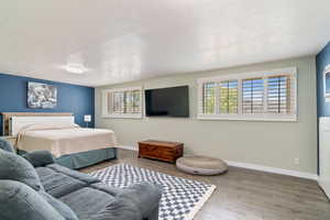 Bedroom featuring a textured ceiling and wood finished floors