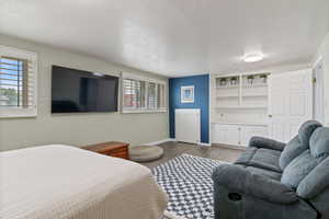 Bedroom featuring a textured ceiling and wood finished floors