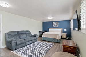 Bedroom featuring a textured ceiling and wood finished floors