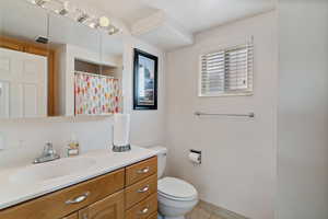 Full bathroom with vanity, tile patterned floors, and a shower with curtain