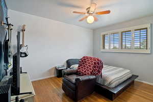 Bedroom featuring hardwood / wood-style flooring and a ceiling fan