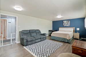 Bedroom featuring a textured ceiling and wood finished floors