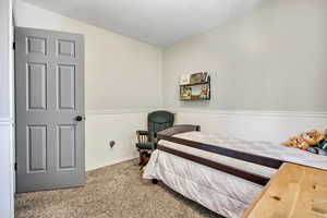 Carpeted bedroom featuring baseboards