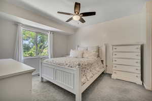 Bedroom with light carpet and ceiling fan