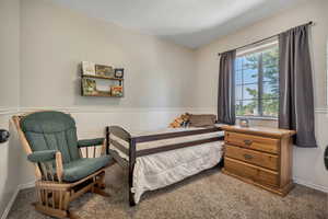 Bedroom featuring carpet floors and baseboards
